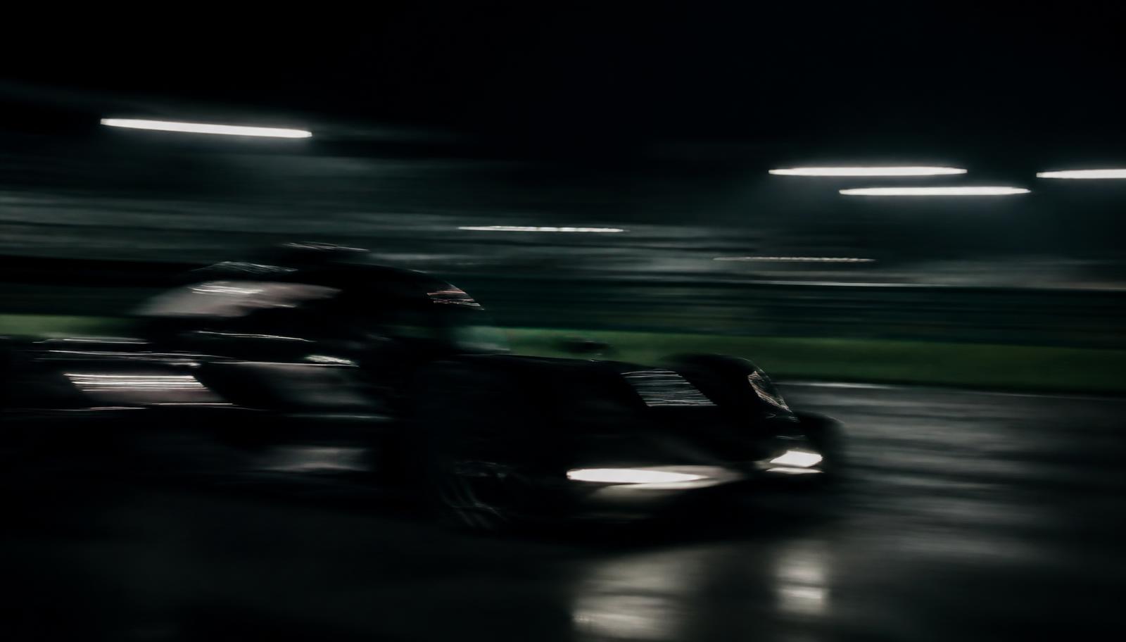 Motion-blurred racing car at night